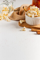 Cozy and aesthetic beige composition with sweet popcorn. Autumn, winter food concept.