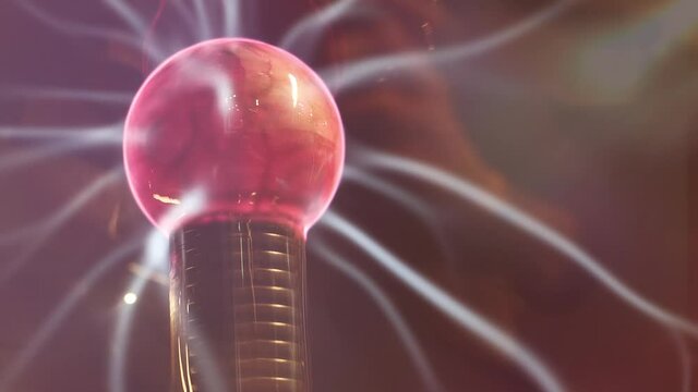 Plasma sphere with electric beam and strikes. Science education experiment with Tesla ball. Blue sparks and red nucleus in plasma ball with high energy and voltage.