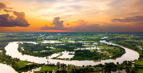 Panorama Top view Aerial photo from flying drone.Flooded rice paddies and village.Flooding the fields with water in which rice sown. View from above,chi river,Ubon Ratchathani province,Thailand,ASIA.