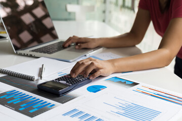 Financial planning and accounting concepts. Women calculate and analyze business and plan their...