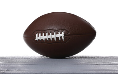 American football ball on grey wooden table against white background