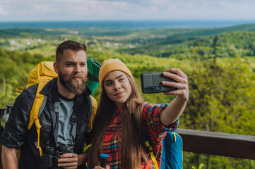 Hikers taking selfie with a smartphone while out in the nature hiking