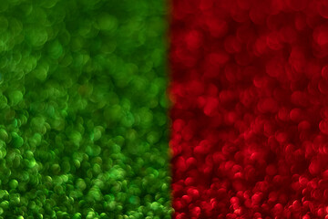 Green and red sparkling glitter bokeh background, christmas abstract defocused texture. Holiday lights