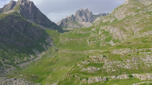 Young couple hiking in trail leading to Kleine Scheidegg from Mannlichen with Eiger, Monch and Jungfrau mountain Swiss Alps in Switzerland.