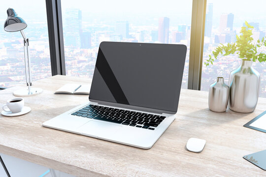 Creative designer desktop with empty laptop computer in modern interior with window and bright city view. Mock up, 3D Rendering.