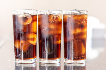 Refreshing Bubbly Soda Pop with Ice Cubes. Cold soda iced drink in a glasses - Selective focus,...