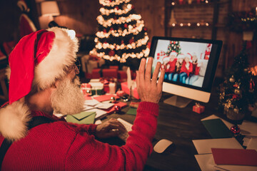 Back view photo portrait santa talking on video connection waving to camera greeting on christmas on quarantine