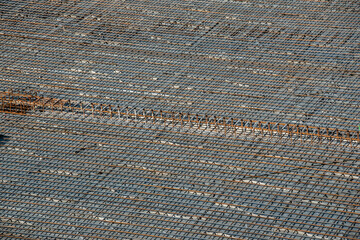 a concrete floor covered with a grid of steel