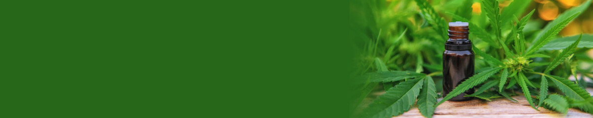 Marijuana oil in a small bottle. Selective focus.