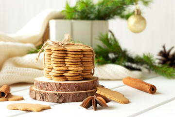 Fototapeta na wymiar Stack of ginger cookies and spices on wooden tabletop