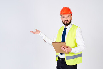 Confused male builder in a helmet on a white background.