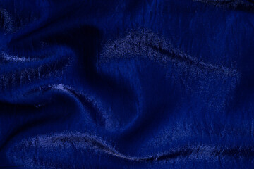 Purple shiny fabric as background. Top view.