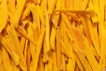 Dry tasty mango slices as a background.