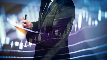 Double exposure of young business man and digital number of stock market background to represent...