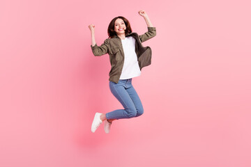 Full length photo of hooray short hairdo lady jump hands fists wear khaki shirt jeans sneakers...