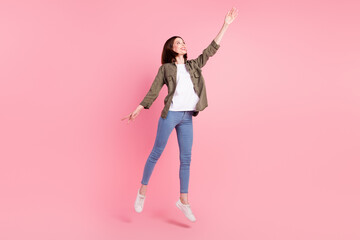 Full body photo of nice short hairdo lady dance look up wear khaki shirt jeans sneakers isolated on pink color background © deagreez