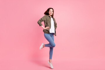Full size photo of cool brunette hairdo lady jump wear khaki shirt jeans sneakers isolated on pink...