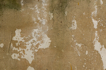 The background of the old wall with the remnants of plaster and whitewash, the texture of the old wall. Background and texture, for creating graphic and photo resources.