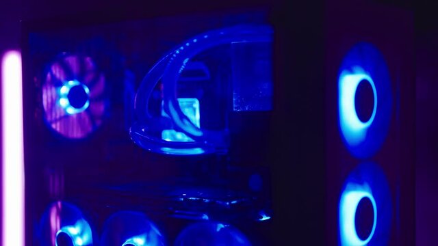Reveal gaming RGB PC with water cooling tubes surrounded with neon lights 4K