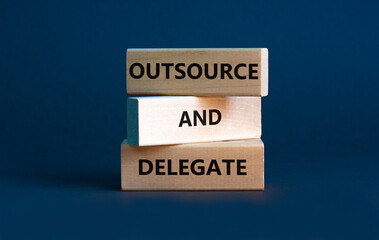 Outsource and delegate symbol. Concept words 'Outsource and delegate'. Beautiful grey background....