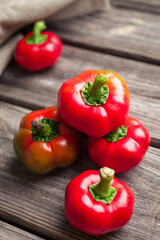 Fresh raw sweet red pepper on old wooden background. Pepper ratunda (gogoshar). Food background 