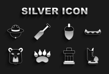 Set Bear paw footprint, Kayak, Skates, Inukshuk, Beaver animal, Acorn, Canadian ranger hat and Paddle icon. Vector