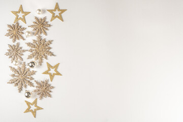 Christmas Holidays Composition. Celebratory, creative gold Christmas snowflakes on a white background. Flat lay, top view