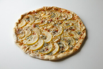 Pizza with cheese and pear fruit on table