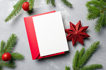 Fototapeta na wymiar Christmas and New Year greeting card mockup with red envelope and festive decorations