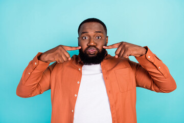 Photo of young black man pouted cheeks hold breath childish playful isolated over teal color...