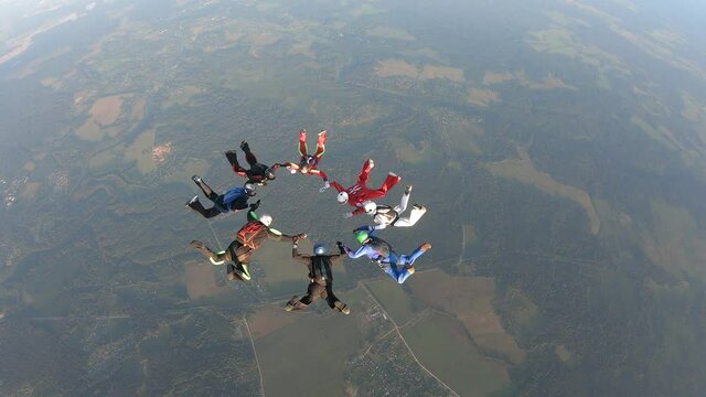 Skydiving.  Skydivers are making formation in the sky.