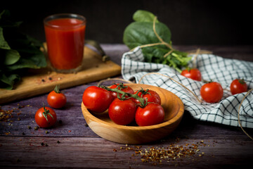 cherry tomatoes and tomato juice on a black background.