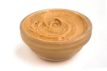 bowl of peanut butter on white background