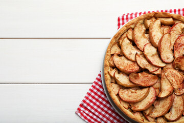Delicious apple pie on white wooden table, top view. Space for text