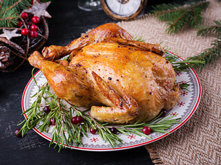 Baked  chicken or turkey. The Christmas table is served with turkey, decorated with bright tinsel. Fried chicken, table. Christmas dinner. Table setting. Top view, above