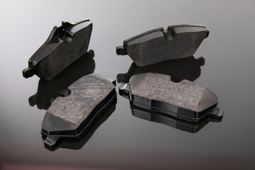 image photograph of brake pads on a black and gray background - obrazy, fototapety, plakaty