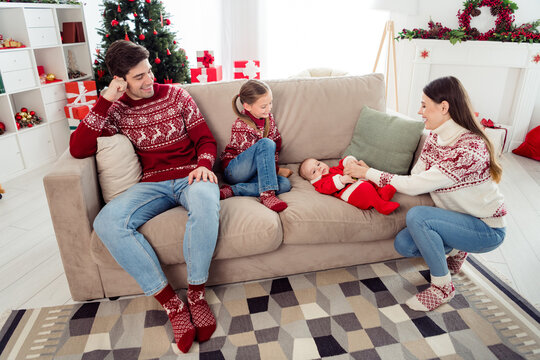Full body photo of young family happy positive smile sit couch comfort winter holiday december indoors
