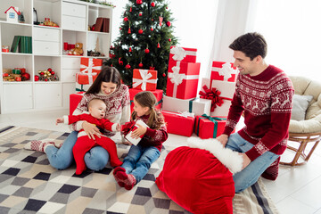Obraz na płótnie Canvas Full lenght photo of young cheerful family happy positive smile santa claus bag present box new year winter indoors