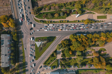 Drones point of view - traffic jam top view, transportation concept, intersection crossroad aerial view from above. Road traffic on crossroad or intersection downtown.