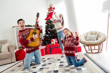 Photo of cool pretty big family wear christmas sweaters dancing showing hard rock signs smiling...