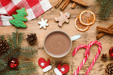 Fototapeta na wymiar Flat lay composition with delicious hot chocolate and Christmas decor on wooden table