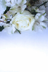 White roses and alstroemeria on a white background. Festive wedding bouquet. Background for greeting cards, invitations, greetings.