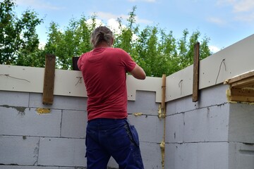 The mason to formwork concreting walls at construction site