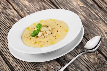 Soup dish with beef and vegetables on a plate on the desk
