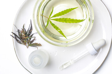 Medical marijuana oil. CBD oil or THC tincture in bowl.