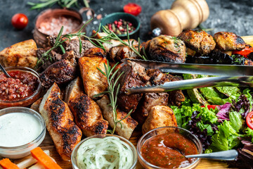 Grilled assorted meat and vegetables on tray. Grill Barbecue menu. Restaurant menu, dieting,...