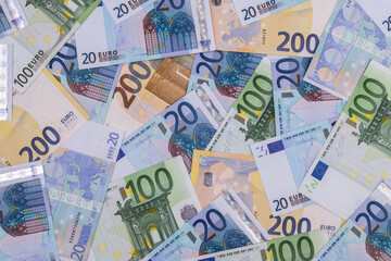 Banknotes in denominations of 20 and 200 euros against the background of other European banknotes of various denominations