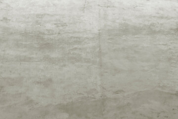 Shabby wall of an old house with uneven crumbling plaster. Yellow-gray abstract texture.