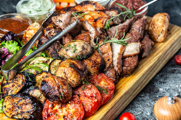 grilled meat platter and vegetables on tray. Grill Barbecue menu. Restaurant menu, dieting, cookbook recipe