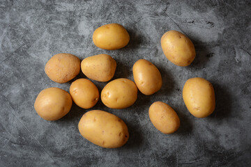 pile of potatoes on the gray background - closeup
